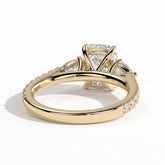 Elongated Cushion lab-grown diamond three-stone engagement ring in 14K (585) yellow gold, on white background 