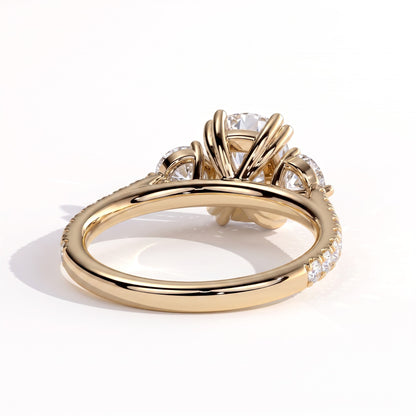 Elongated Cushion lab-grown diamond three-stone engagement ring in 18K (750) yellow gold, on white background 