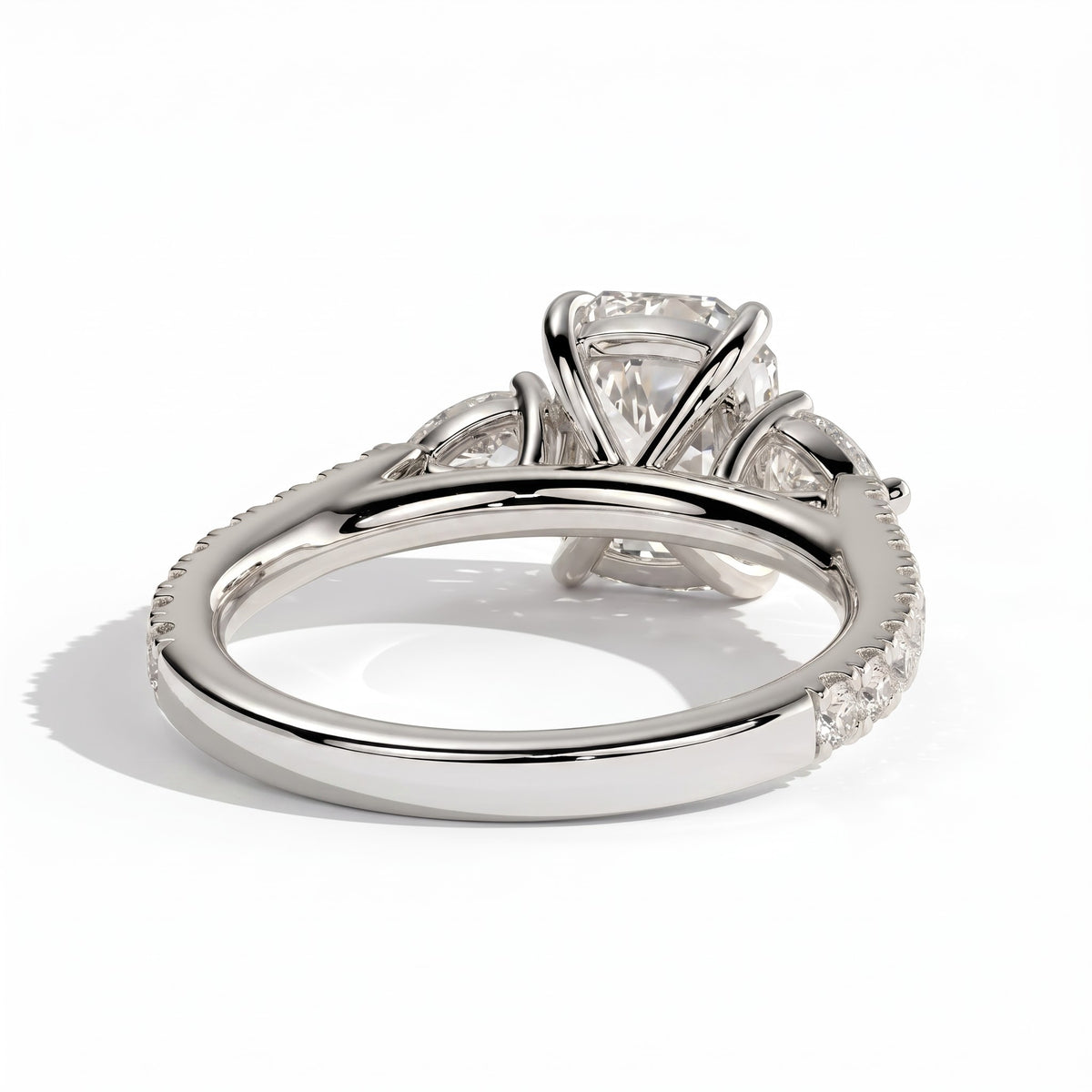 Elongated Cushion lab-grown diamond three-stone engagement ring in 950 platinum, on white background 