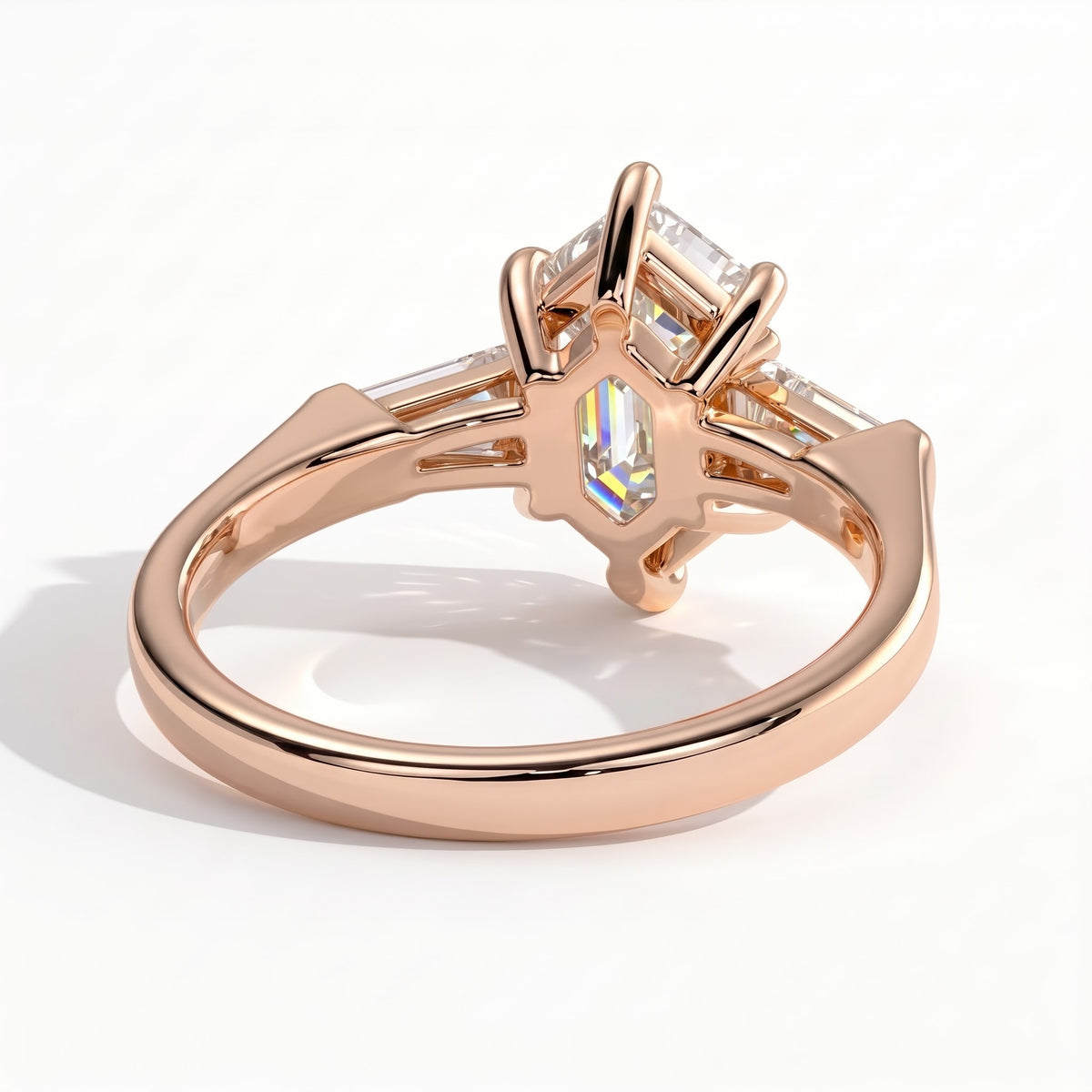Elongated Hexagon lab-grown diamond three-stone engagement ring in 14K (585) rose gold, on white background 