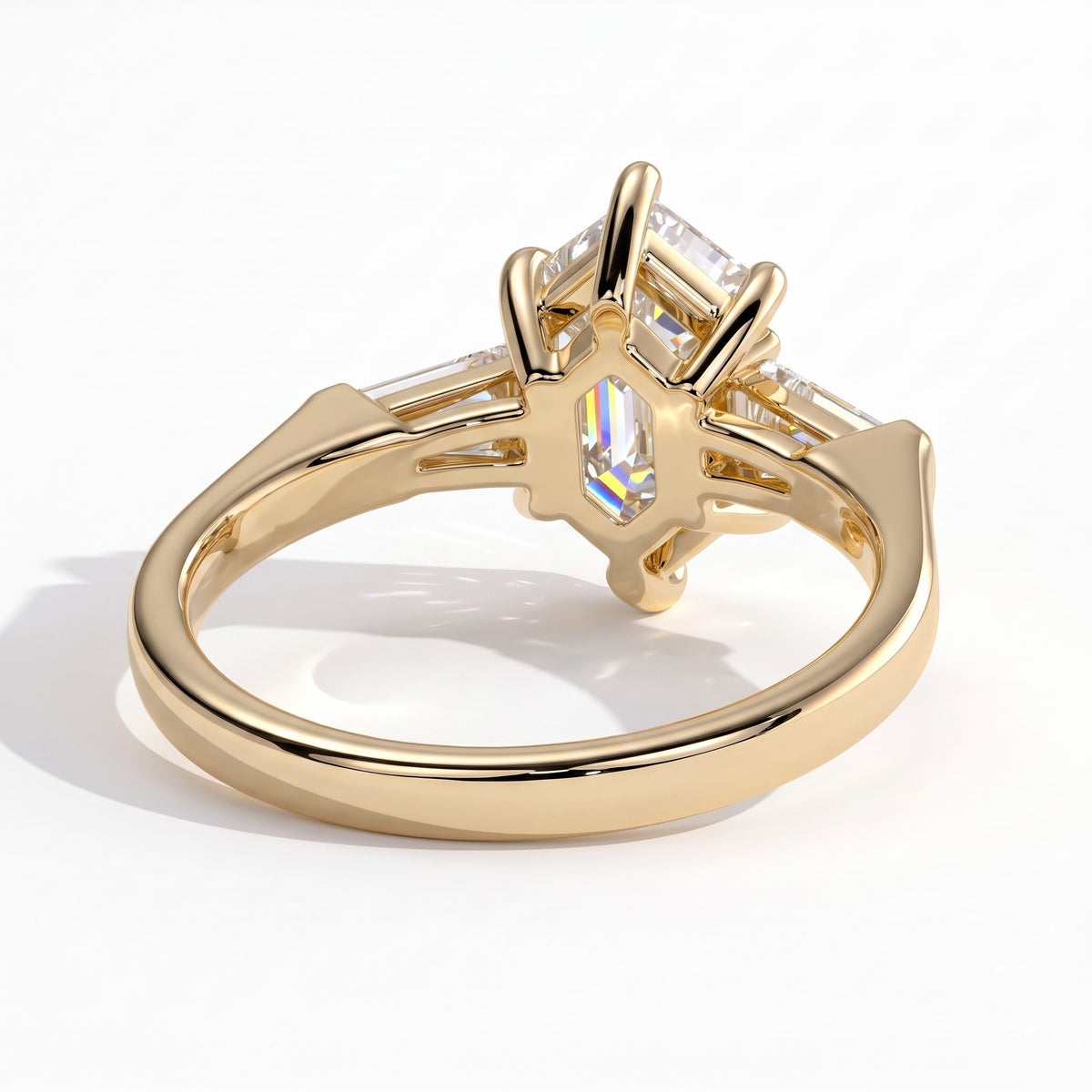Elongated Hexagon lab-grown diamond three-stone engagement ring in 18K (750) yellow gold, on white background 