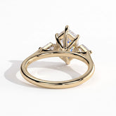 Elongated Hexagon lab-grown diamond three-stone engagement ring in 18K (750) yellow gold, on white background 