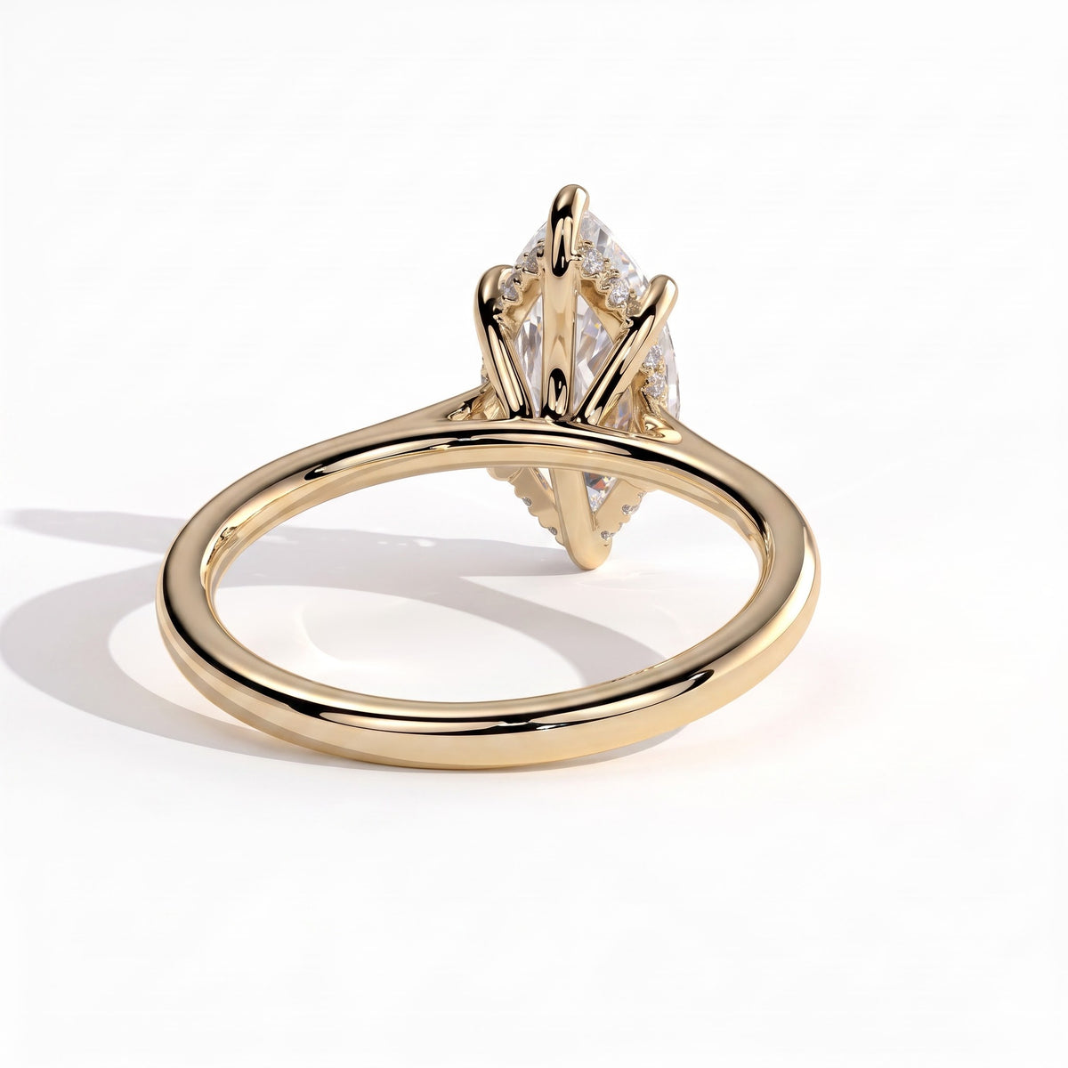 Marquise lab-grown diamond halo engagement ring in 18K (750) yellow gold, on white background 