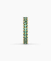 Helene round green gemstone eternity ring in 750 yellow gold, side profile view 