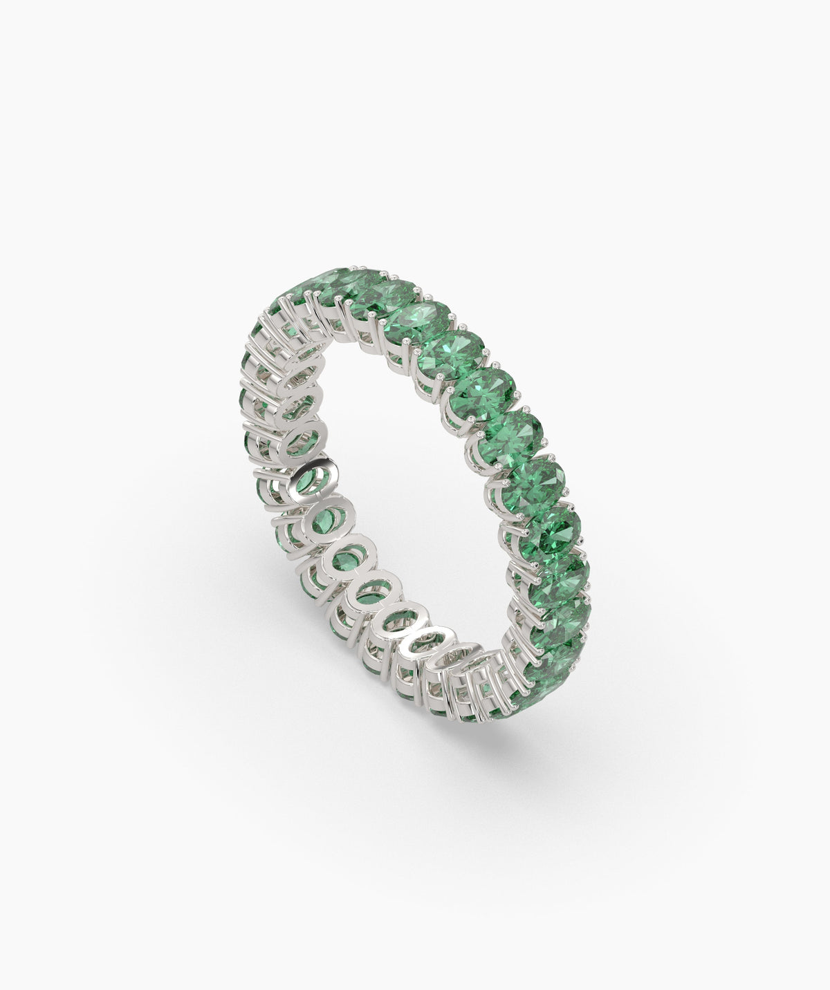 Helene round green gemstone eternity ring in 950 platinum, angled view 