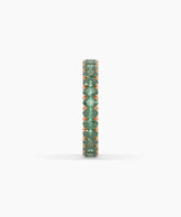 Helene round green gemstone eternity ring in 750 rose gold, side profile view 