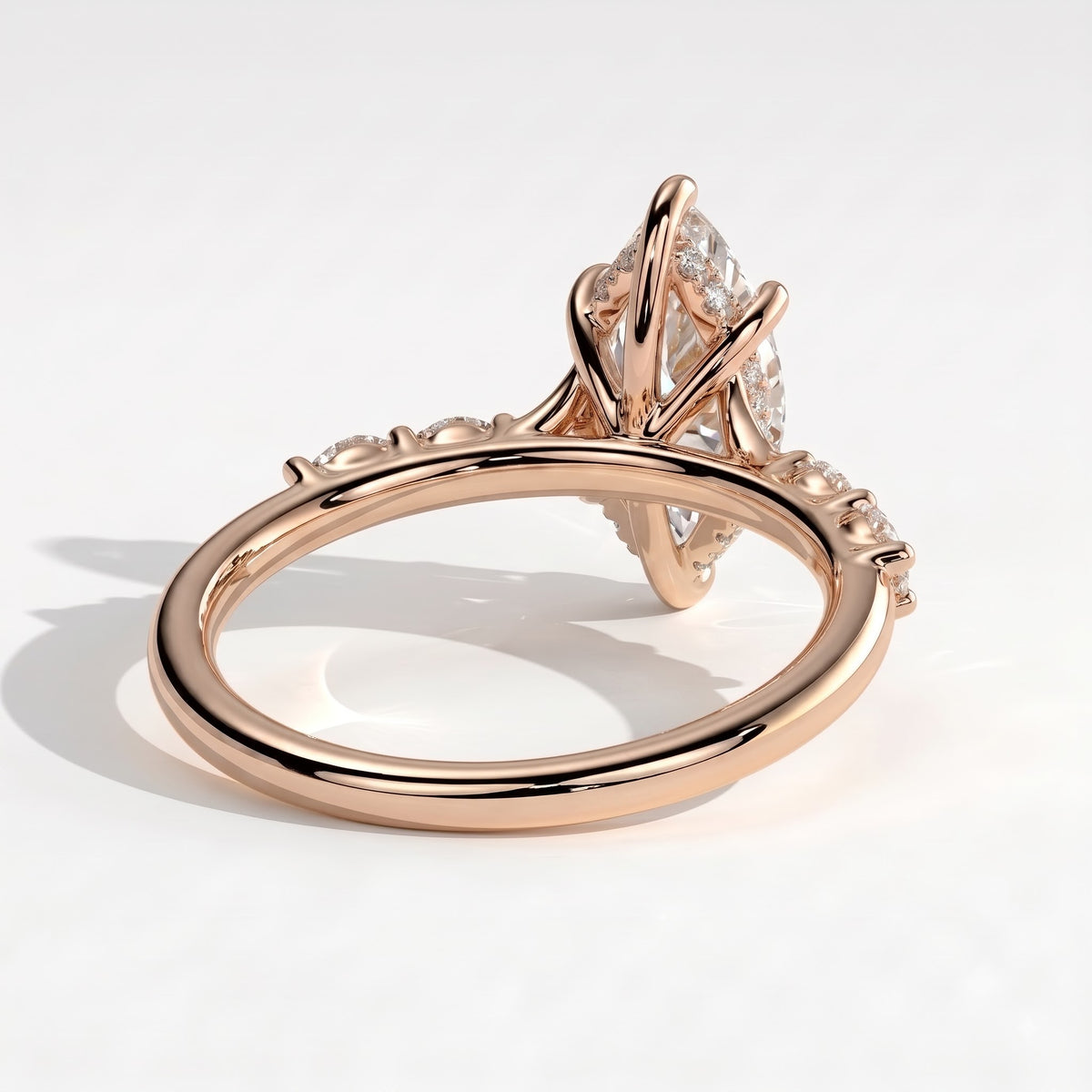 Marquise lab-grown diamond halo engagement ring in 18K (750) rose gold, on white background 