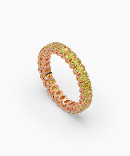 Nina round yellow gemstone eternity ring in 750 rose gold, angled view 