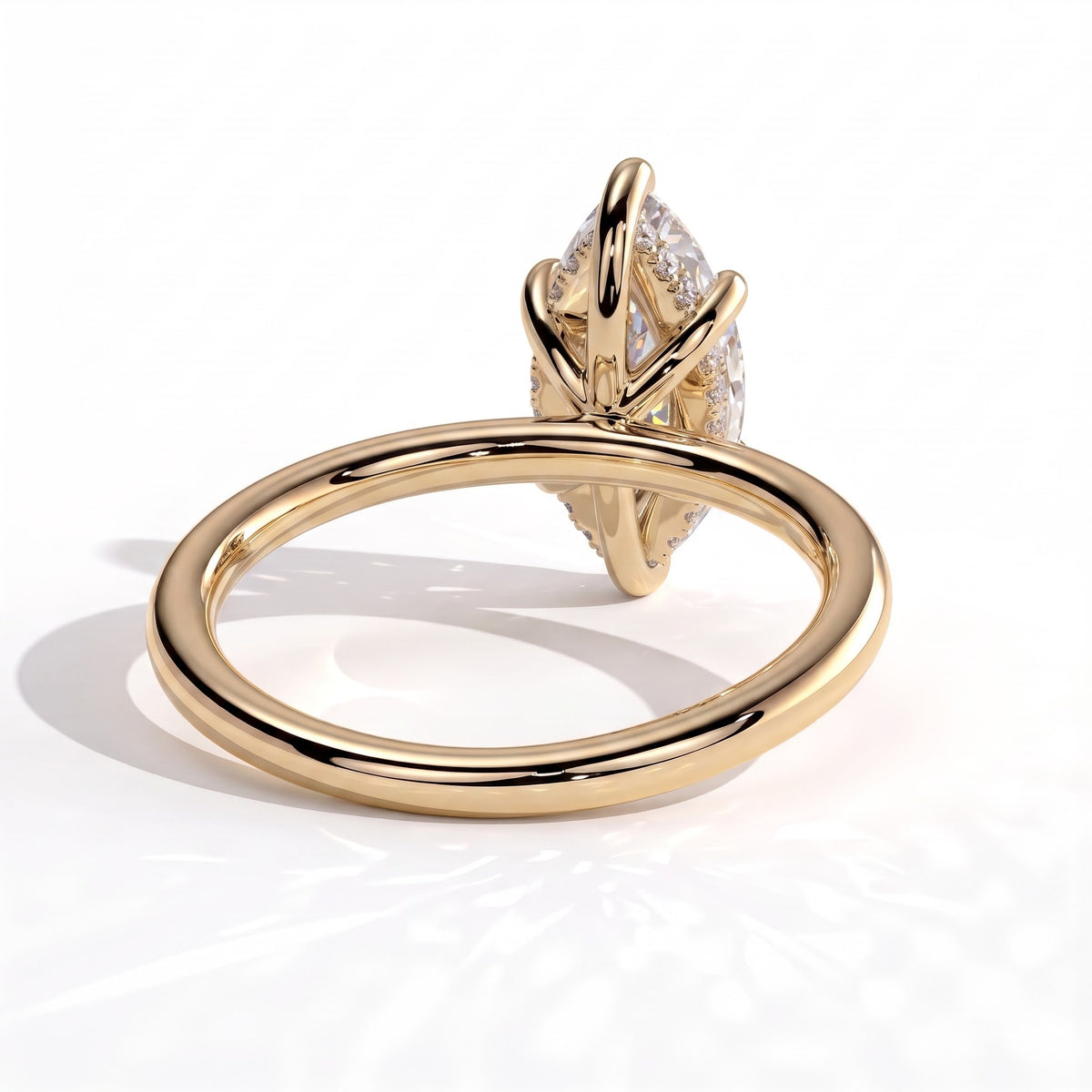 Marquise lab-grown diamond solitaire engagement ring in 18K (750) yellow gold, on white background 