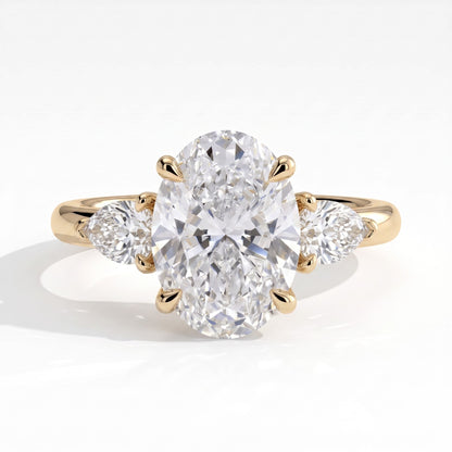 Oval lab-grown diamond three-stone engagement ring in 14K (585) yellow gold, front view 