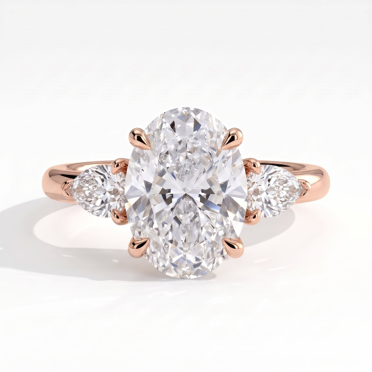 Oval lab-grown diamond three-stone engagement ring in 14K (585) rose gold, front view 
