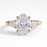 Oval lab-grown diamond three-stone engagement ring in 18K (750) yellow gold, front view 