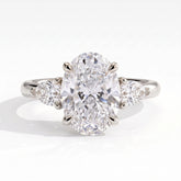 Oval lab-grown diamond three-stone engagement ring in 950 platinum, front view 