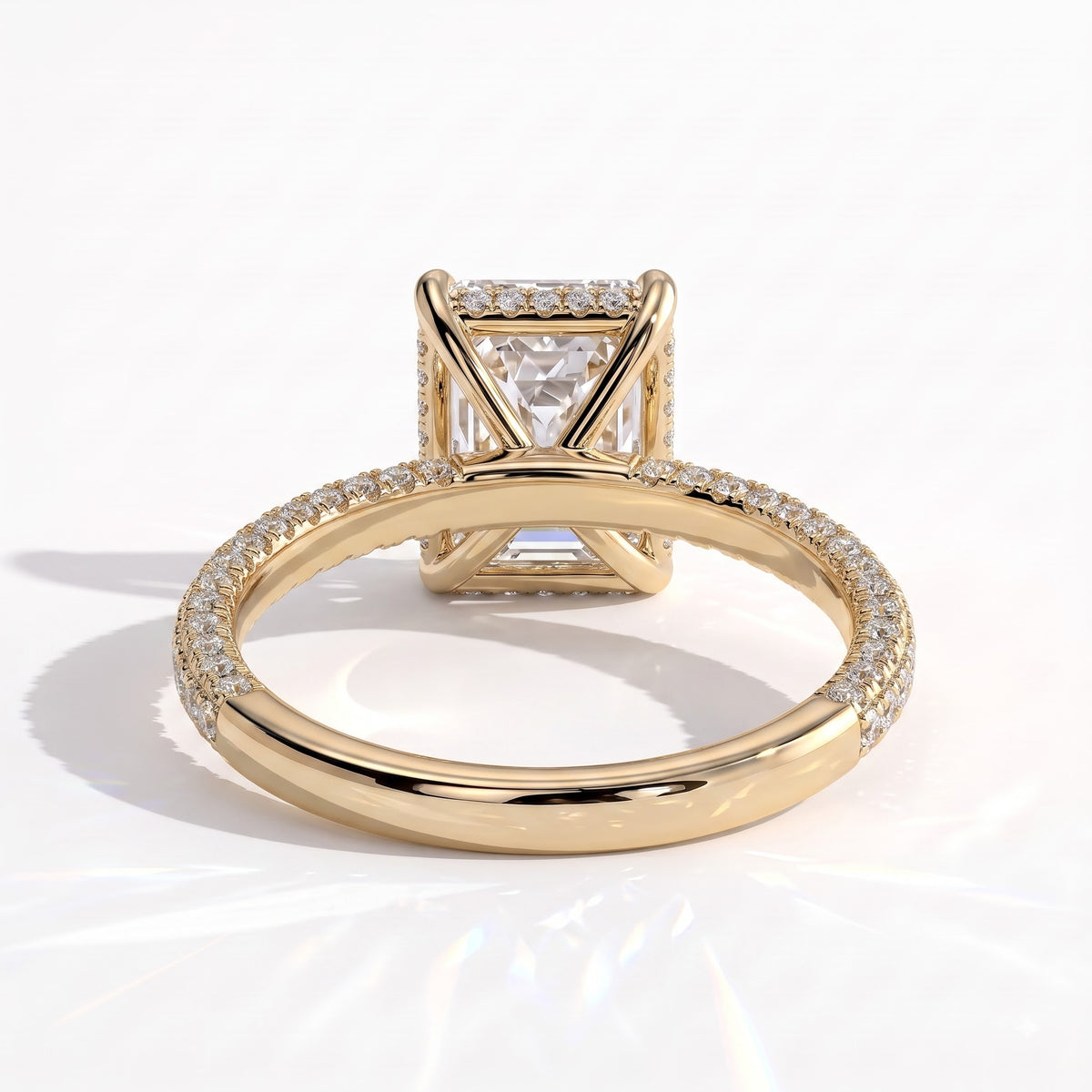 Radiant lab-grown diamond halo engagement ring in 14K (585) yellow gold, on white background 