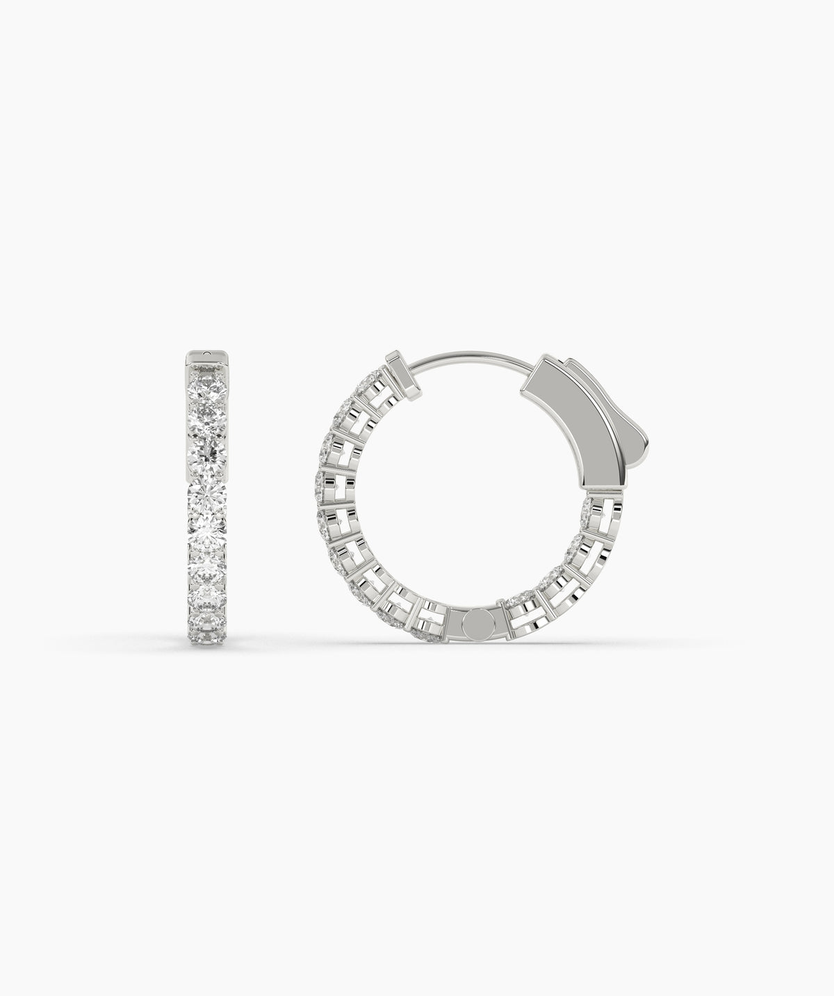 Silver hoop earrings with clear gemstones on a white background. 