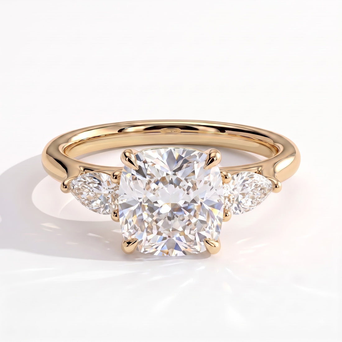 Cushion lab-grown diamond three-stone engagement ring in 14K (585) yellow gold, front view 