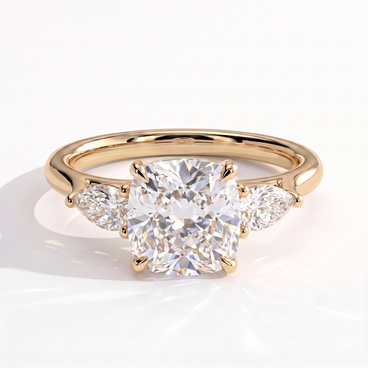 Cushion lab-grown diamond three-stone engagement ring in 14K (585) yellow gold, front view 