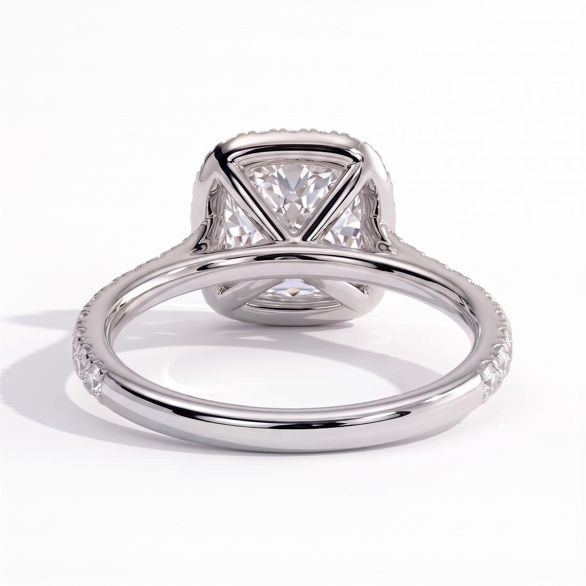 Cushion lab-grown diamond halo engagement ring in 950 platinum, on white background 