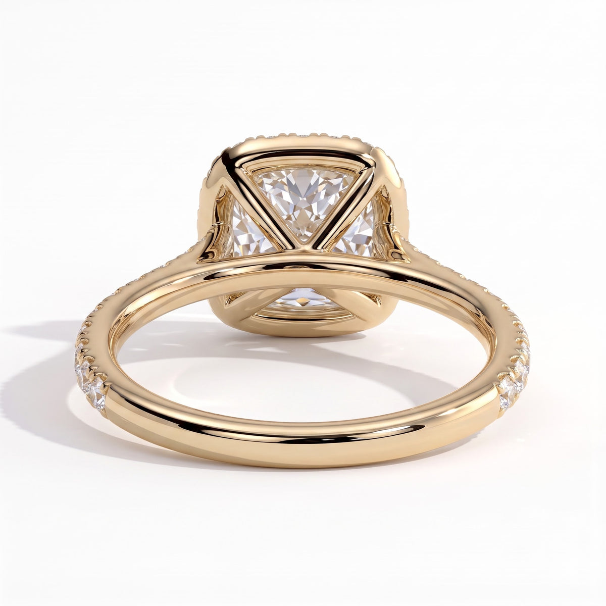 Cushion lab-grown diamond halo engagement ring in 14K (585) yellow gold, on white background 