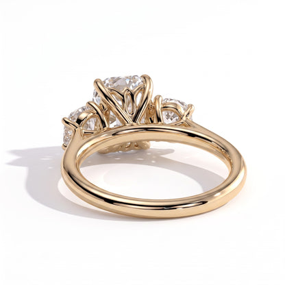 Elongated Cushion lab-grown diamond three-stone engagement ring in 14K (585) yellow gold, on white background 