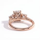 Elongated Cushion lab-grown diamond three-stone engagement ring in 14K (585) rose gold, on white background 