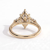 Marquise lab-grown diamond three-stone engagement ring in 14K (585) yellow gold, on white background 