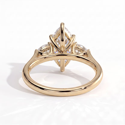 Marquise lab-grown diamond three-stone engagement ring in 14K (585) yellow gold, on white background 