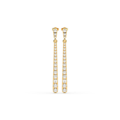 Gold earrings with clear stones on a white background. 