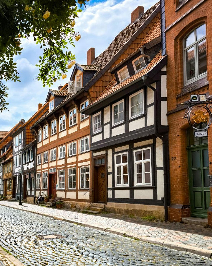 Cobbled street with traditional half-timbered houses in a quaint German town.