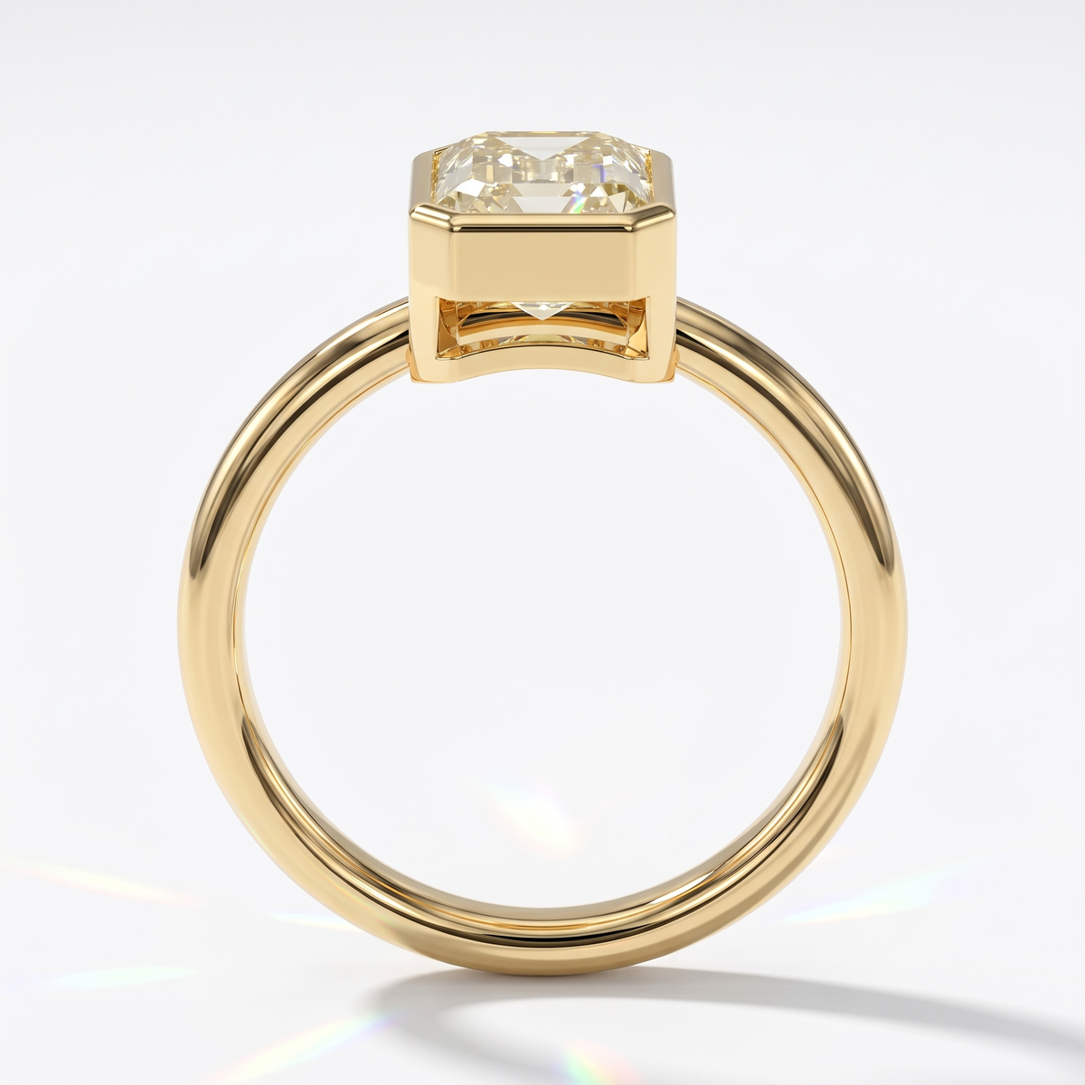 Fancy Intense Yellow emerald cut lab-grown diamond bezel ring in 14K (585) yellow gold, front view 
