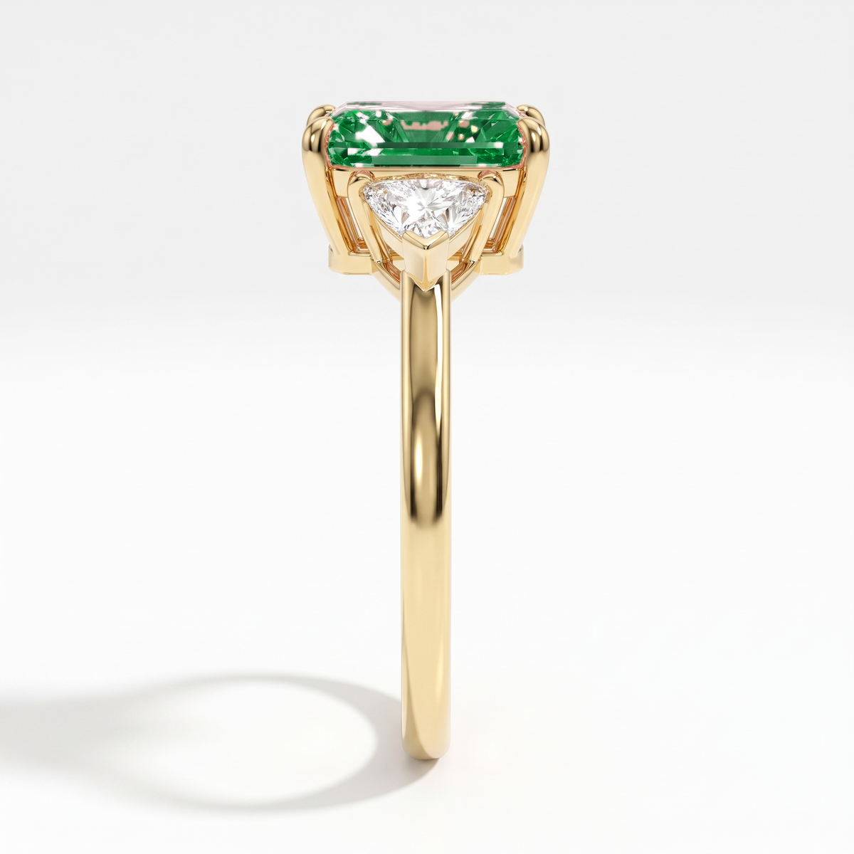 Fancy Vivid Green radiant lab-grown diamond three-stone ring with trillion side diamonds in 14K (585) yellow gold, side profile 