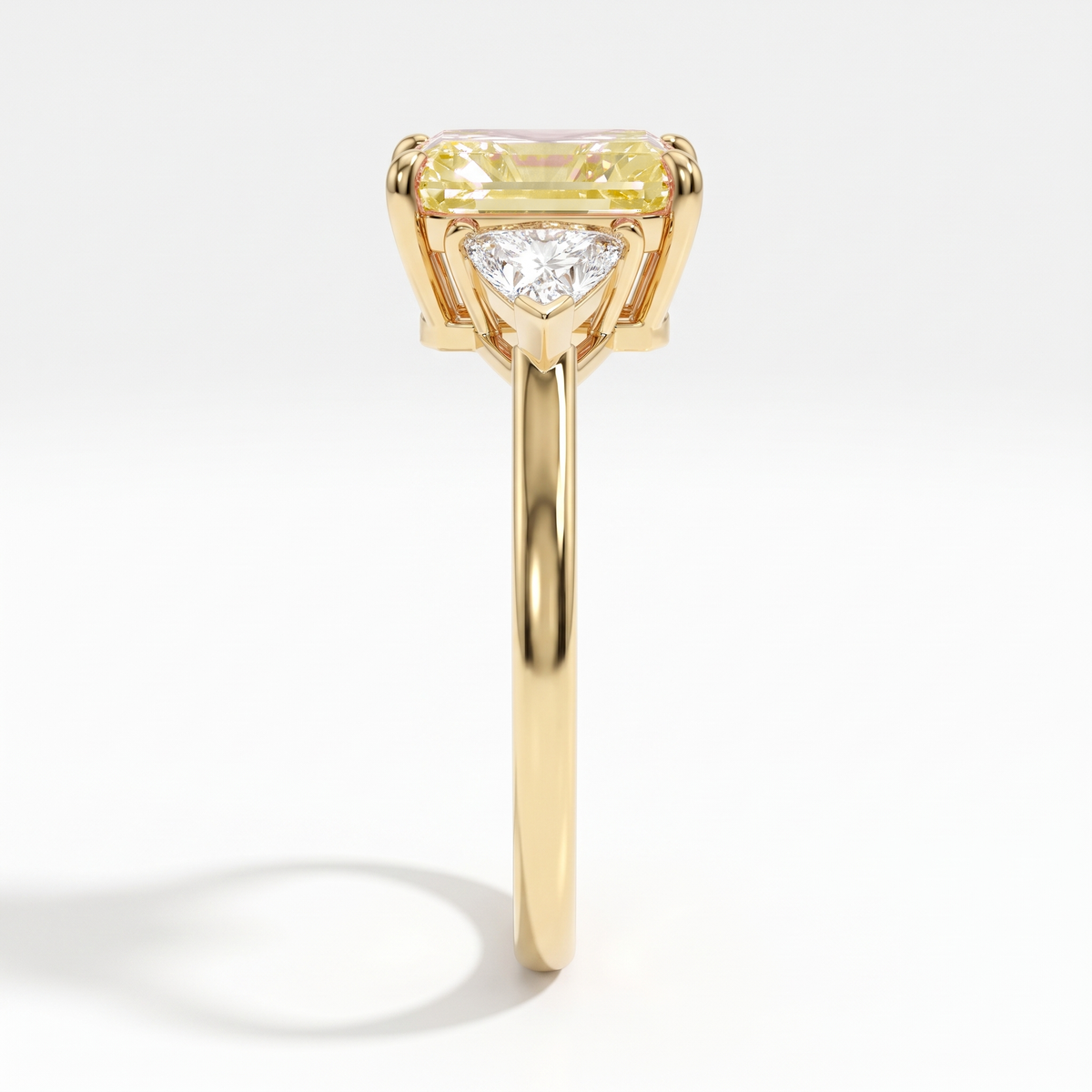 Fancy Vivid Yellow radiant lab-grown diamond three-stone ring with trillion side diamonds in 14K (585) yellow gold, side profile 