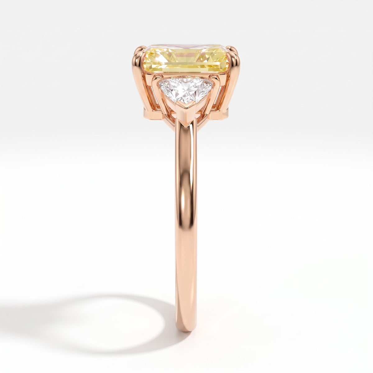 Fancy Vivid Yellow radiant lab-grown diamond three-stone ring with trillion side diamonds in 14K (585) rose gold, side profile 