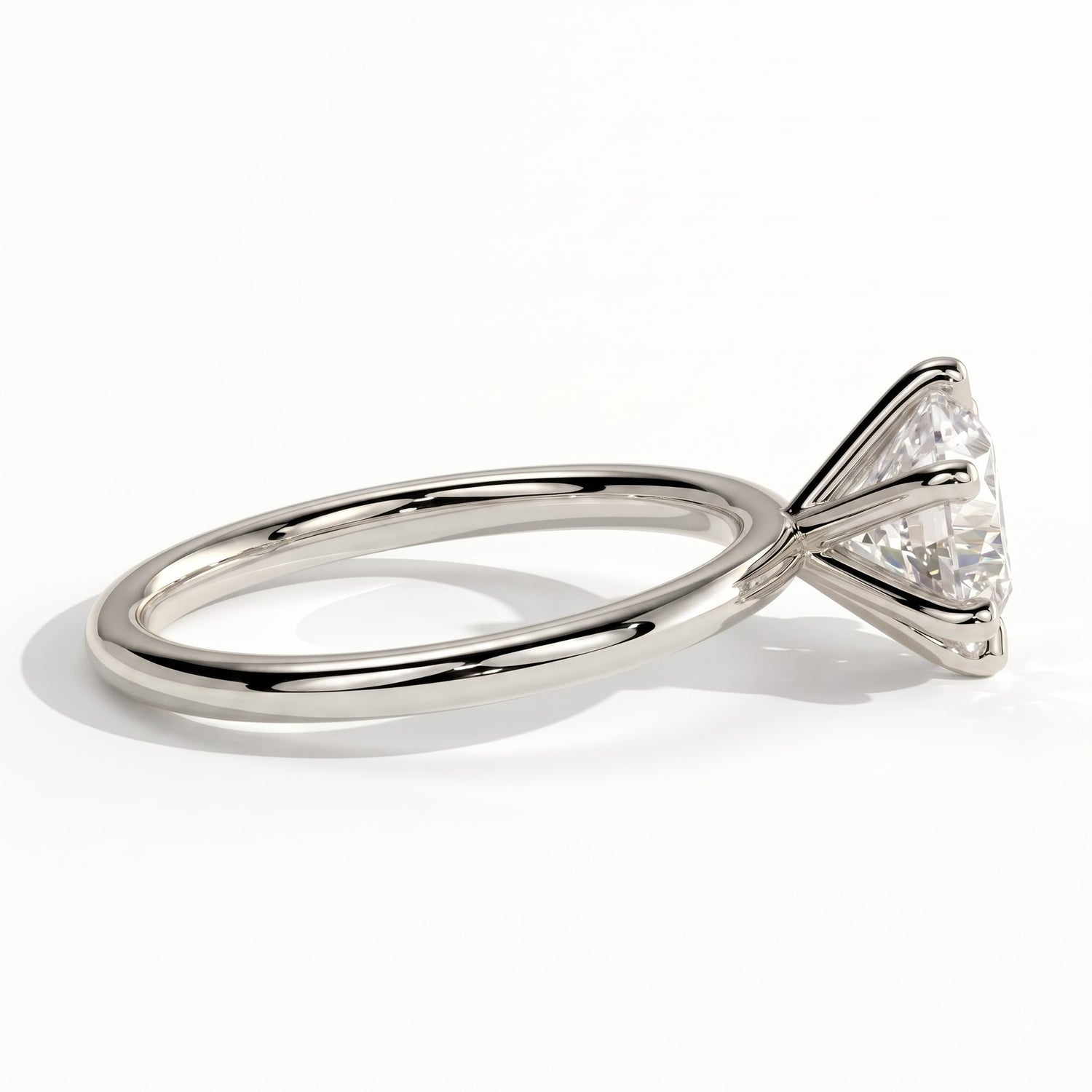 A rose gold engagement ring featuring a large round brilliant-cut diamond, shown in a three-quarter side view on a clean white background. 
