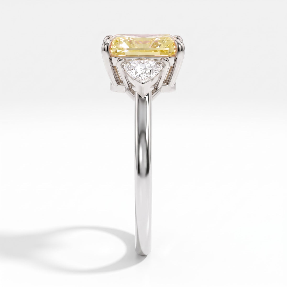 Fancy Vivid Yellow radiant lab-grown diamond three-stone ring with trillion side diamonds in 14K (585) white gold, side profile 