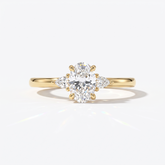 Oval cut lab-grown diamond three-stone engagement ring with pear side stones in 14K (585) yellow gold, front view 