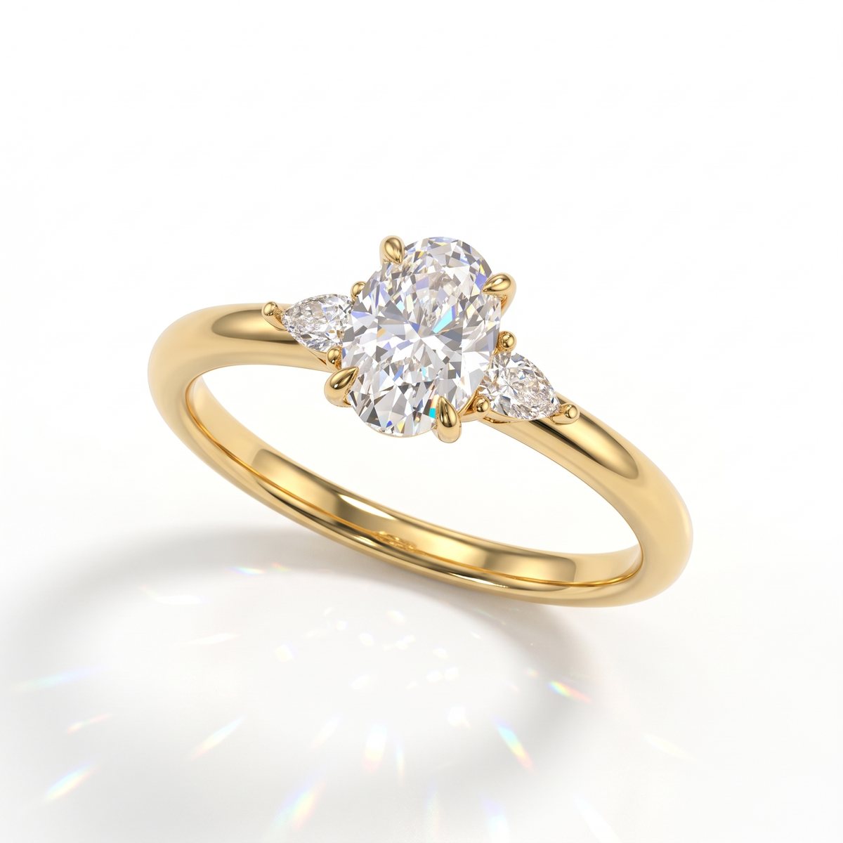 Oval cut lab-grown diamond three-stone engagement ring with pear side stones in 14K (585) yellow gold, angled view 
