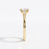 Oval cut lab-grown diamond three-stone engagement ring with pear side stones in 18K (750) yellow gold, side view 
