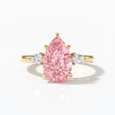 Fancy Vivid Pink pear cut lab-grown diamond three-stone ring with pear side diamonds in 14K (585) yellow gold, front view 