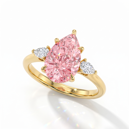 Fancy Vivid Pink pear cut lab-grown diamond three-stone ring with pear side diamonds in 14K (585) yellow gold, angled view 