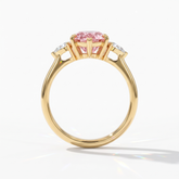 Fancy Vivid Pink pear cut lab-grown diamond three-stone ring with pear side diamonds in 14K (585) yellow gold, upright profile view 
