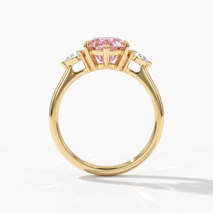 Fancy Vivid Pink pear cut lab-grown diamond three-stone ring with pear side diamonds in 14K (585) yellow gold, upright profile view 