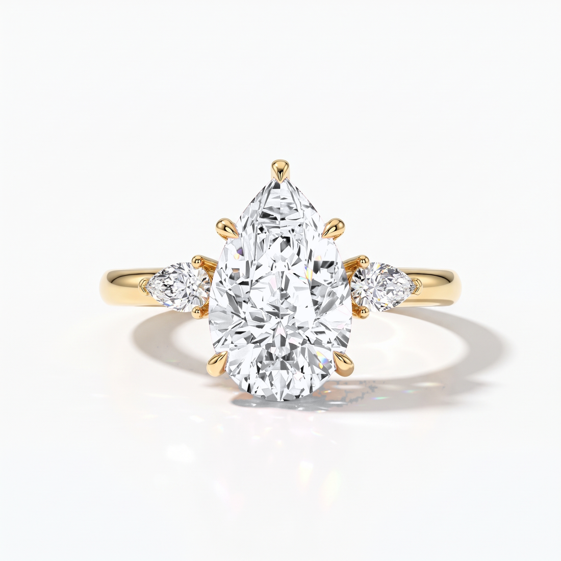 Pear cut lab-grown diamond three-stone engagement ring with pear side stones in 14K (585) yellow gold, front view 