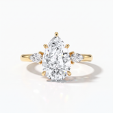 Pear cut lab-grown diamond three-stone engagement ring with pear side stones in 18K (750) yellow gold, front view 