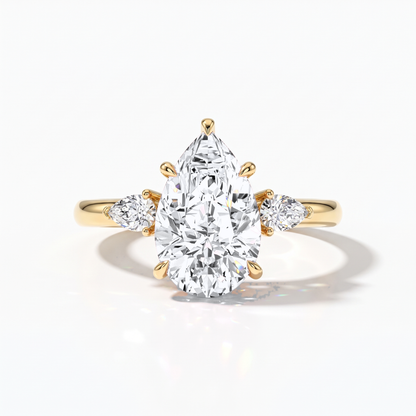Pear cut lab-grown diamond three-stone engagement ring with pear side stones in 18K (750) yellow gold, front view 