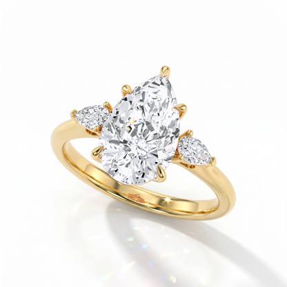 Pear cut lab-grown diamond three-stone engagement ring with pear side stones in 18K (750) yellow gold, angled view 