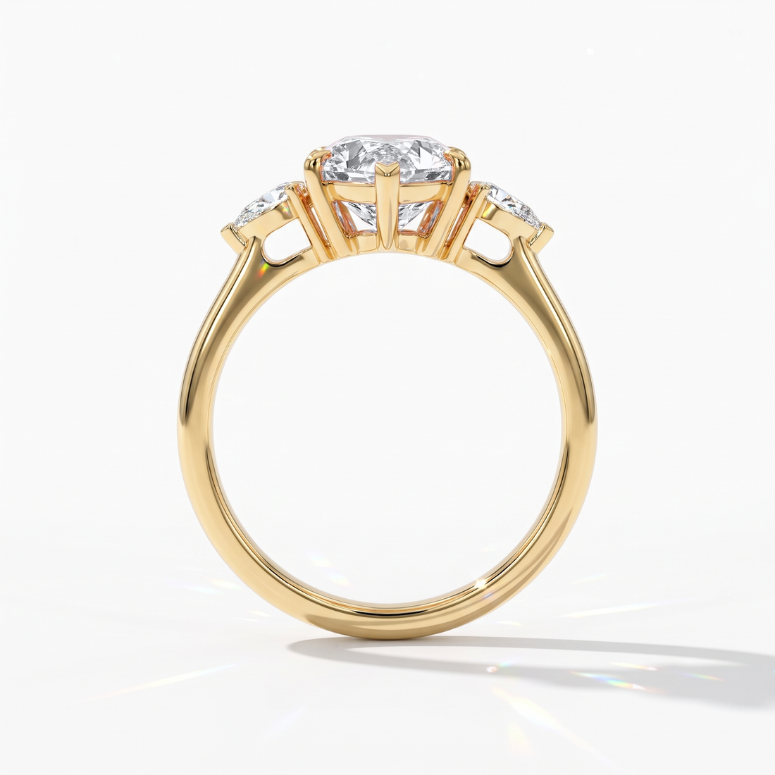 Pear cut lab-grown diamond three-stone engagement ring with pear side stones in 14K (585) yellow gold, upright profile view 