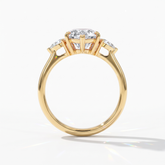 Pear cut lab-grown diamond three-stone engagement ring with pear side stones in 14K (585) yellow gold, upright profile view 