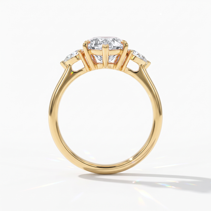 Pear cut lab-grown diamond three-stone engagement ring with pear side stones in 14K (585) yellow gold, upright profile view 