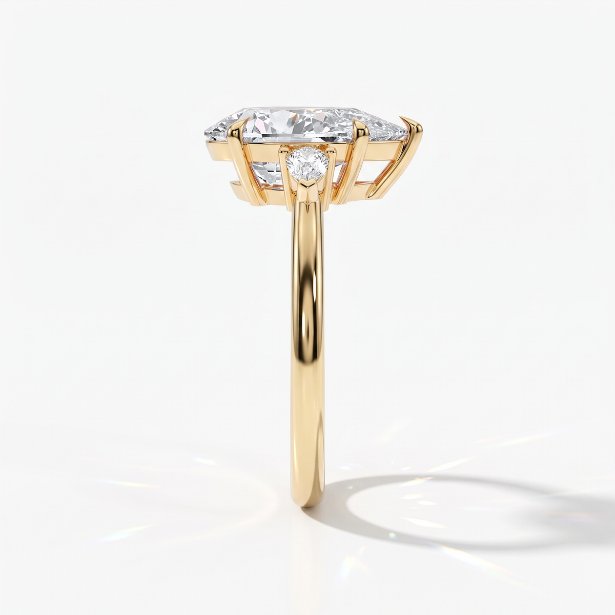 Pear cut lab-grown diamond three-stone engagement ring with pear side stones in 14K (585) yellow gold, side view 